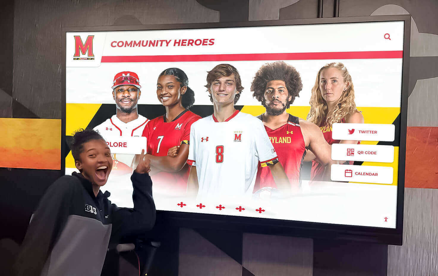 Student engaging with digital community heroes recognition display